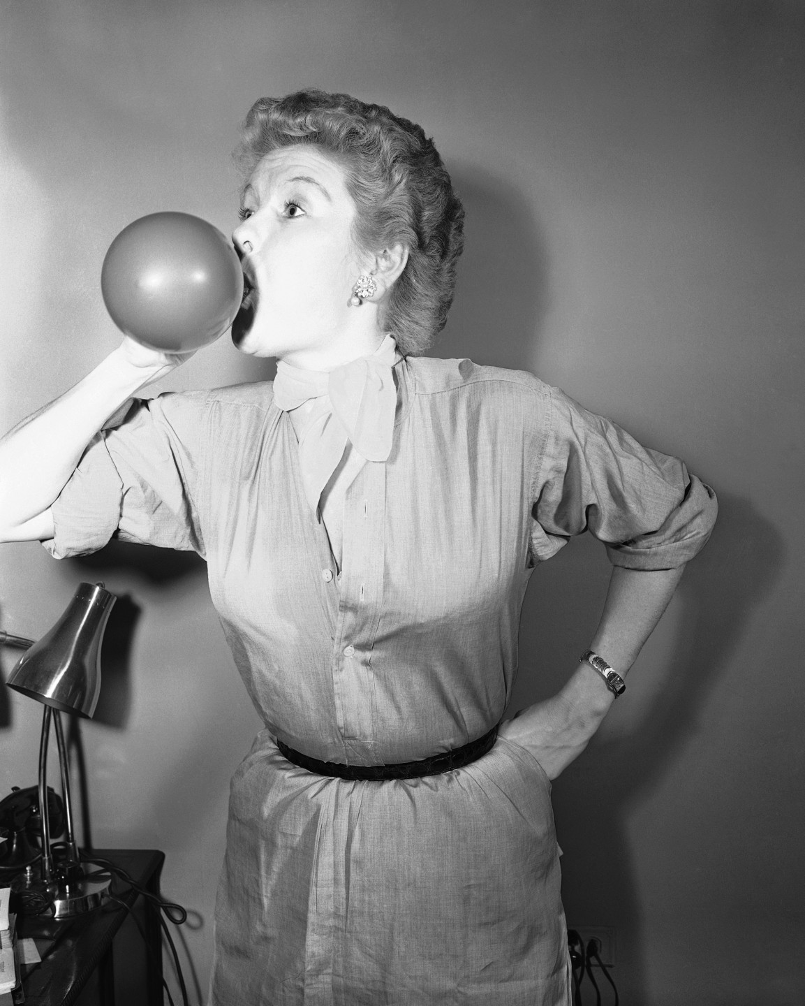 Stritch blows up balloons as a voice training exercise in November 1954.