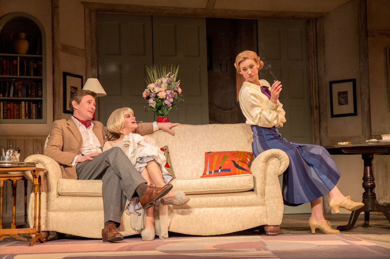 Charles (Charles Edwards) gets cozy with dead wife Elvira (Jemima Rooper) to the annoyance of second wife Ruth (Charlotte Parry) in Blithe Spirit.