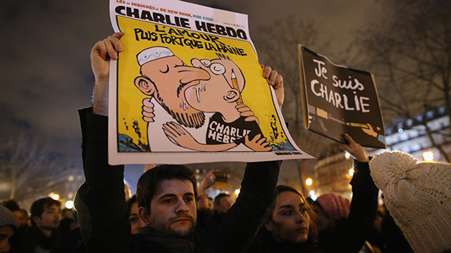 People hold a vigil at the Place de la Republique (Republic Square) for victims of the terrorist attack, on January 8, 2015  in Paris, France. Twelve people were killed yesterday including two police officers as two gunmen opened fire at the offices of the French satirical publication Charlie Hebdo.  (Photo by Dan Kitwood/Getty Images)