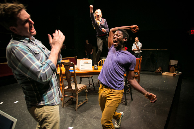 Another White Man (Patrick Jones), Sarah (Megan Trout) and Another Black Man (Rotimi Agbabiaka) improvise a fight.