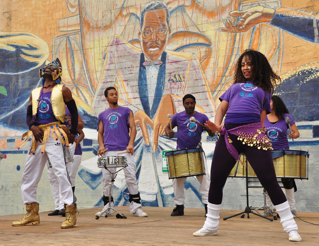 A dance troupe rehearses while Duke Ellington, in mural form, looks on at the African American Art and Culture Complex. 
