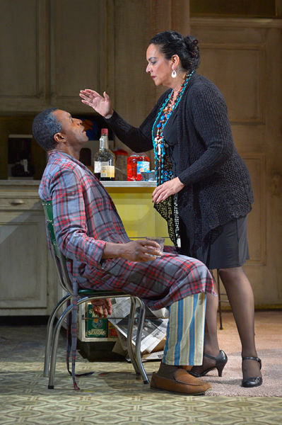The Church Lady (Catherine Castellanos) prays for Walter “Pops” Washington (Carl Lumbly, left) in Stephen Adly Guirgis’s Pulitzer Prize–winning dark comedy, Between Riverside and Crazy. Photo by Kevin Berne