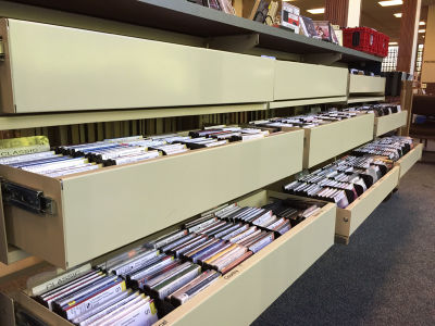 Physical CD racks at the Sonoma County Library, where Collections Manager David Dodd says he's waiting for streaming services for public libraries to improve before adopting one for patrons' use.