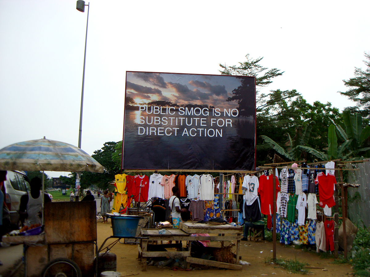 Amy Balkin, PUBLIC SMOG IS NO SUBSTITUTE FOR DIRECT ACTION, Billboard, Bonamoussadi, Douala, Cameroon, 2009.