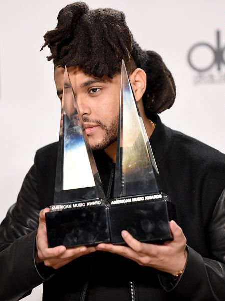 Recording artist The Weeknd, winner of Favorite Soul/R&B Male Artist and Favorite Soul/R&B Album, poses in the press room during the 2015 American Music Awards at Microsoft Theater 