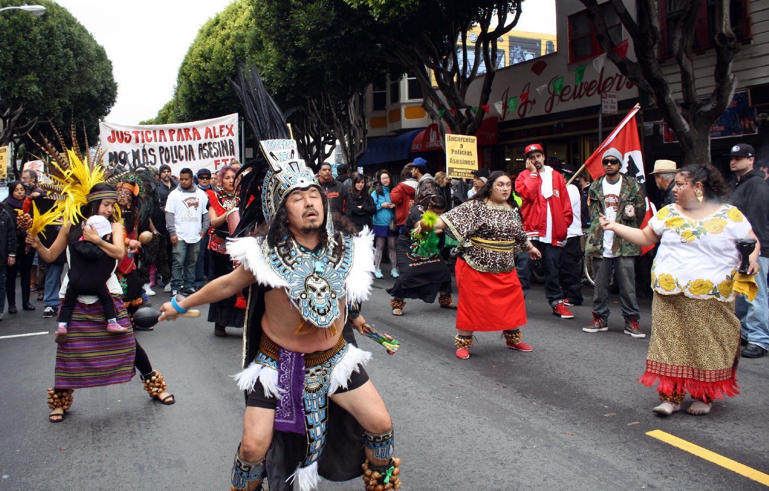 Aztec dancers march for Alejandro Nieto in March 2014.