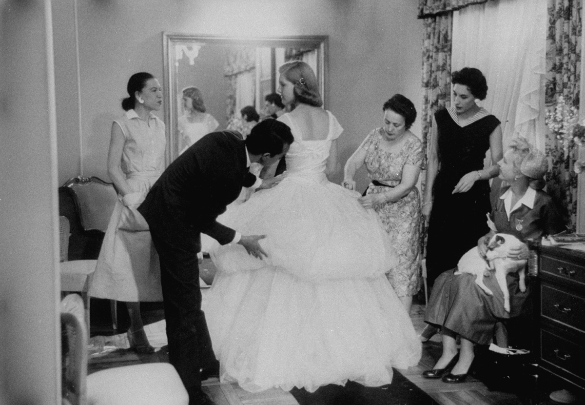 Baroness Aino Bodisco, looking on as Beatrice Lodge is being fitted by fashion designer Oscar de la Renta in her debutante dress.