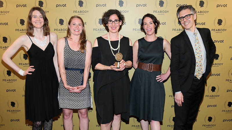 'Serial' producer Julie Snyder stands to the right of Sarah Koenig (center) as she poses with her Peabody award 