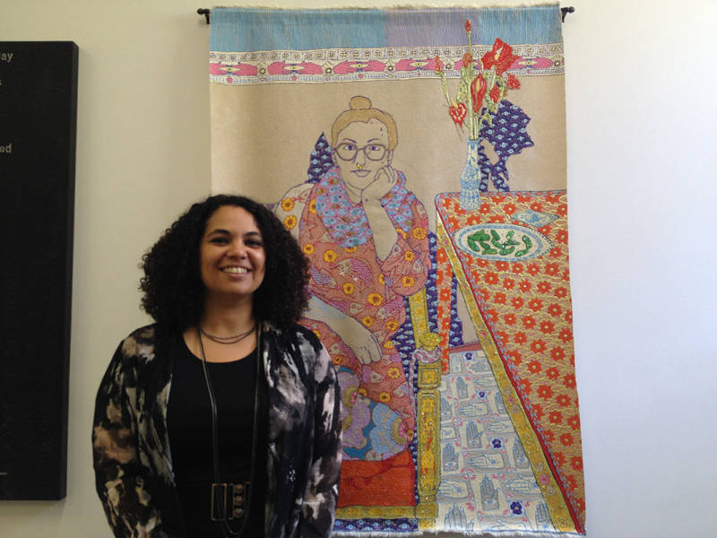 Rhiannon MacFadyen poses with Craig Calderwood's beaded work at Black and White Projects. 
