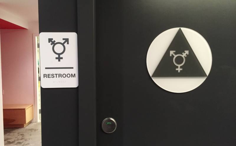Specially ordered signs mark the unisex bathrooms at Counterpulse