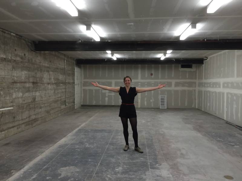 Counterpulse Artistic Director Julie Phelps beams as she shows off a new basement area which may become a rehearsal studio