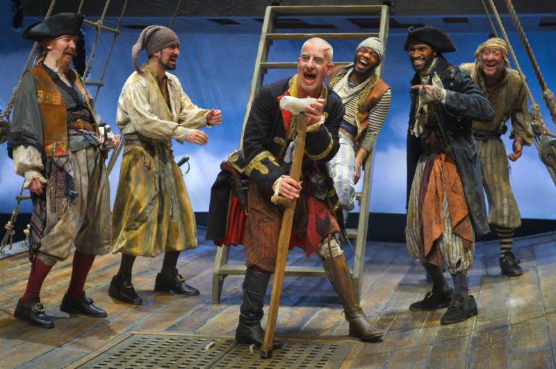 (l to r) Kasey Foster (George Merry), Demetrios Troy (ensemble), Steven Epp (Long John Silver), Travis Delgado (Dick), Anthony Irons (Morgan), and Christopher Donahue (Johnny). Photo: Kevin Berne.