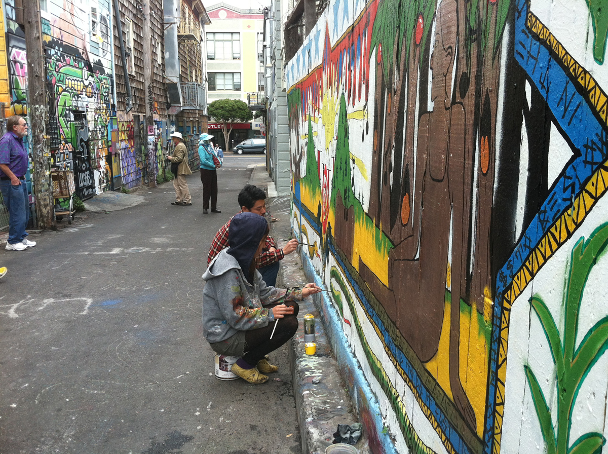 Muralists at work in Clarion Alley.