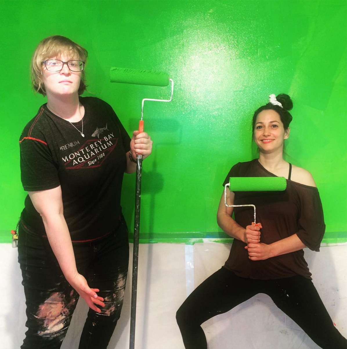 Artists Kate Rhoades and Carolyn Janssen turning a wall into a green screen at the new Royal Production Company.