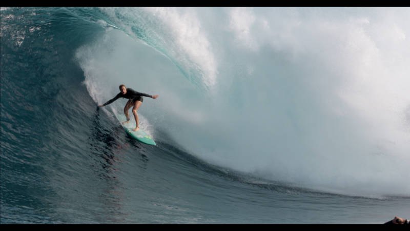 Paige Alms rides a barrel at Jaws off the coast of Maui. She was the first woman to do so.