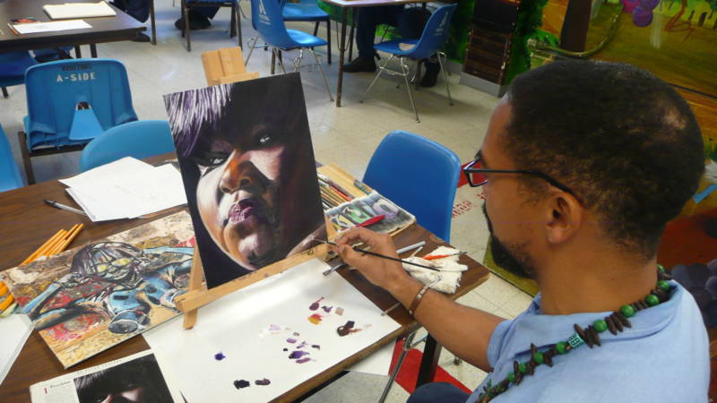 An inmate is putting final touches on an oil painting of actress Gabourey Sidibe.