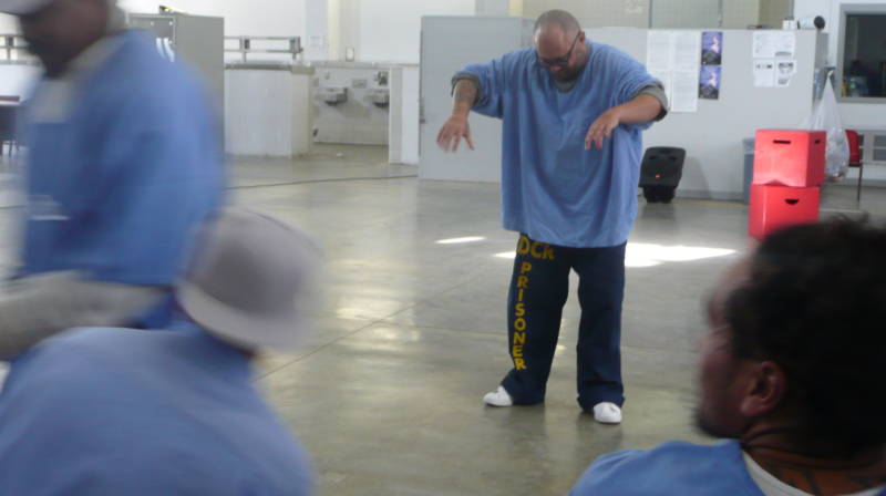 Another inmate pretends to turn on water faucets in a game called "Use One, Choose One."
