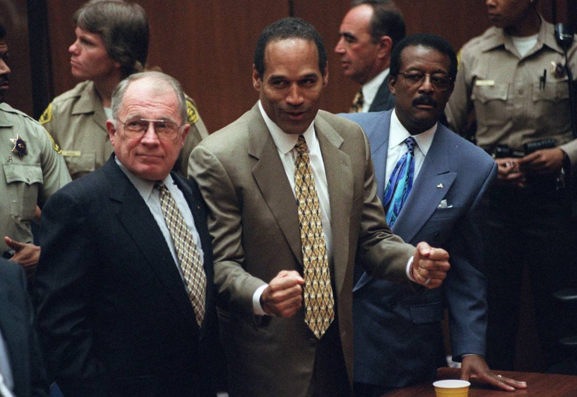 O.J. Simpson reacts as he is found not guilty of murdering his ex-wife, Nicole Brown Simpson, and her friend Ron Goldman at the Criminal Courts Building in Los Angeles on Oct. 3, 1995. At left is defense lawyer F. Lee Bailey and at right, defense attorney Johnnie Cochran Jr.