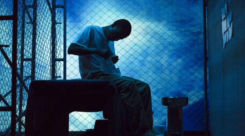 The stage goes blue around the distraught Victor Santiago (Carlos Aguirre) in 'The Box' at Z Space.