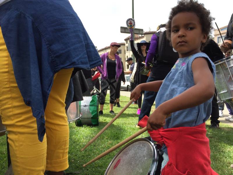 One of many kids who drummed along with Aaron Davis near Lake Merritt on Saturday
