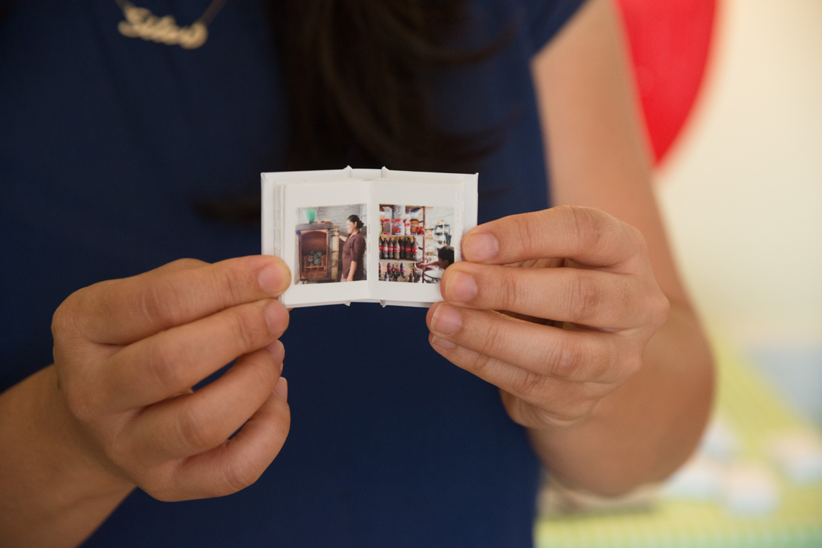 miniature book with family photos from her 'MamaSita's Tiny Tea House' project.