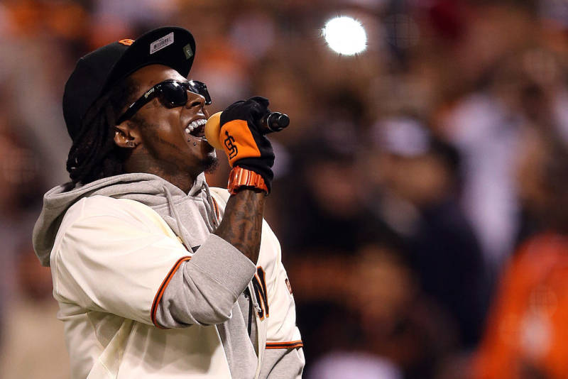 Lil Wayne sings 'Take Me Out to the Ball Game' during the seventh inning of Game Six of the 2012 NLCS Championship in San Francisco.