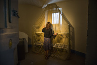In one cell, British director and artist Steve McQueen has draped a gold-plated mosquito net over a bare metal bunk bed.