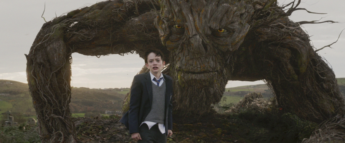 Conor (Lewis MacDougall) is shadowed by The Monster (performed and voiced by Liam Neeson) in J.A. Bayona’s 'A Monster Calls.'