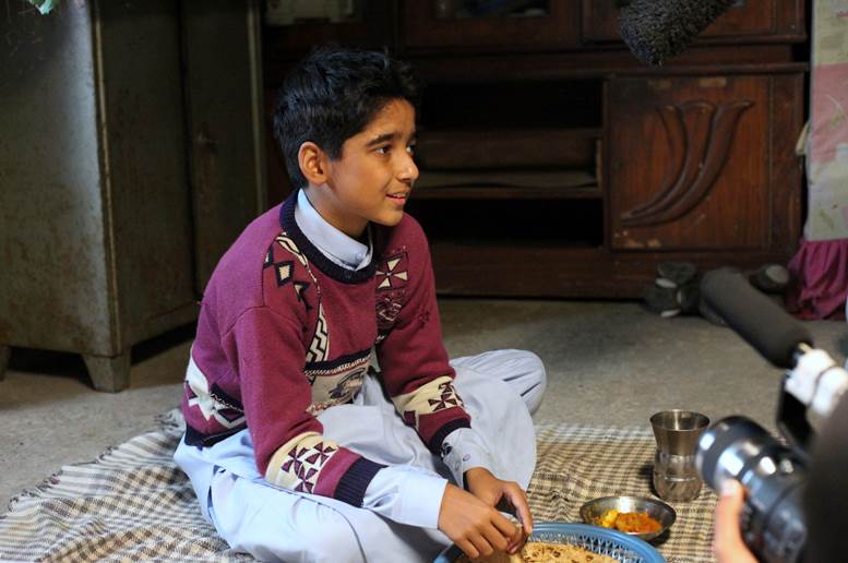 Uzair Ali preparing for a scene in which he’s eating dinner with his character’s brother