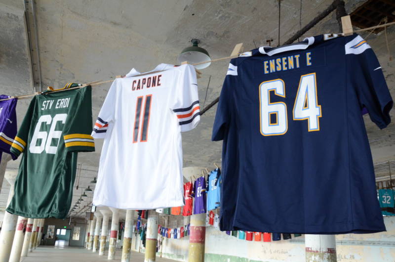 A white number 11 Chicago Bears jersey with the name "Capone" is strung up as part of the art installation "Shortening: Making the Irrational Rational" at Alcatraz on Tuesday, October 25, 2016. According to the artist, the smaller Capone jersey signifies that Capone's sentence, 11 years, should have been longer unlike the nonviolent drug sentences he would like to see shortened.