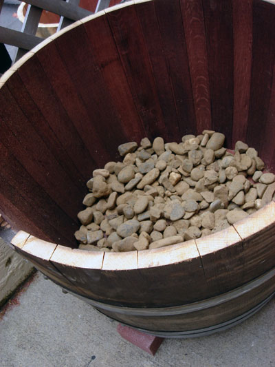 add pebbles to wine barrel