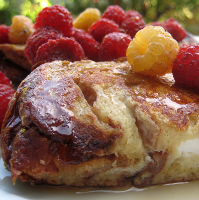 cream cheese and jam stuffed challah french toast with raspberries