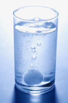 water with antacid symbolically representing an upset stomach