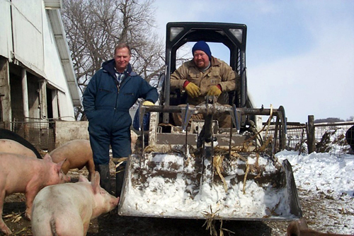 Paul Watson, seen left, heads a network of 500 small farmers who supply pork to Niman Ranch.