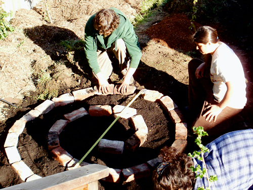 Building the herb spiral. Photo by Sally Carter.