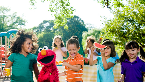 Elmo and kids have a great time enjoying fruits and vegetables as part of Sesame Street’s Food For Thought initiative. © 2010 Sesame Workshop.  Photo by: Gil Vaknin. 