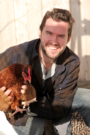 Daniel Klein holding a chicken. Photo: Lars Swanson