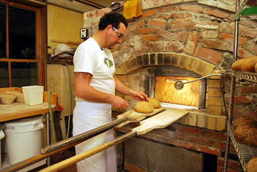 Eduardo Morrell monitors the internal temperature of the bread to gauge its readiness