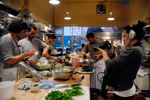 Mirra Fine filming Perennial Plate dinner prep in Tartine Bakery kitchen. Photo by Wendy Goodfriend