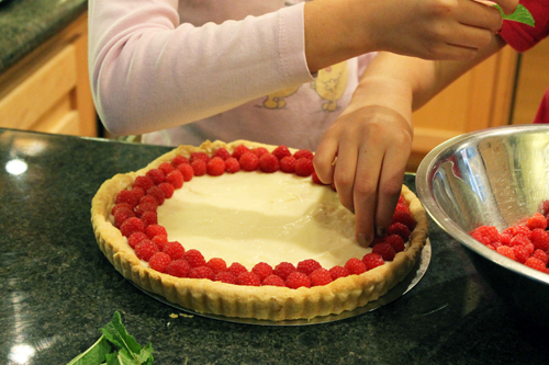 placing the berries on the tart