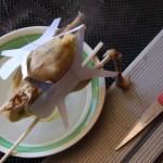 He adds a paper cut out of two people on the chicken, representing mother and child.