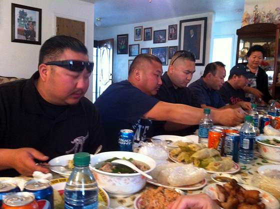 Men sit down to eat.