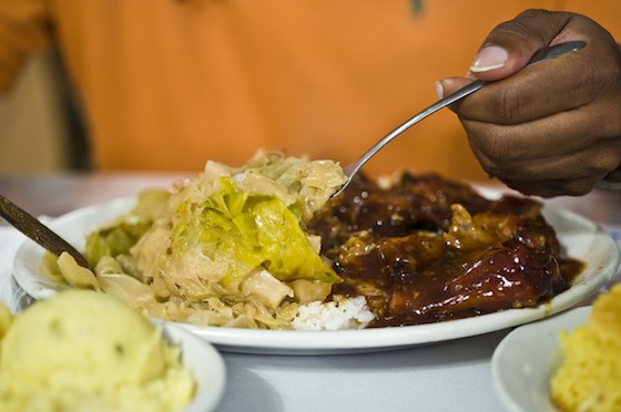 Ribs, cabbage, rice, and potato salad on the side. Photo: Shawn Escoffery
