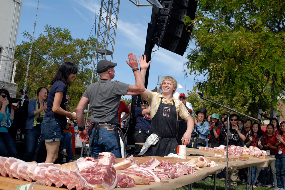 Dave the Butcher hi-fives Daren King at the conclusion of the 3rd Annual Flying Knives Pork Butchery Contest. Photo: Wendy Goodfriend