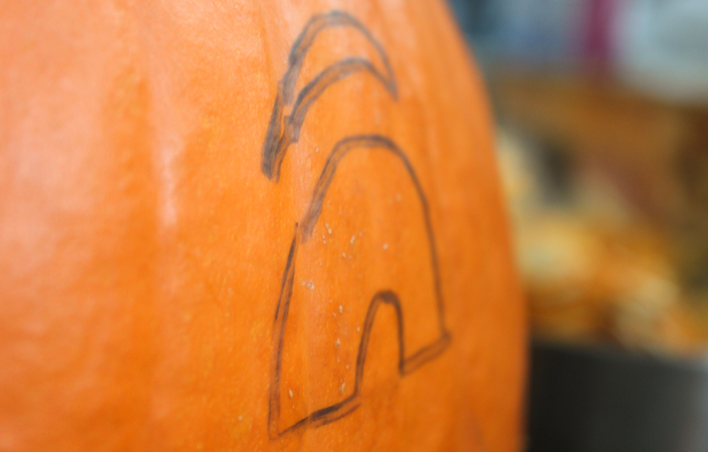 Stenciling a pumpkin to carve it