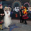 Day of the Dead participants in front of Dia de los Muertos mural in the Mission. Photo: Naomi Fiss
