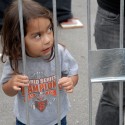 Little girl SF Giants fan behind a barrier. Photo: Wendy Goodfriend