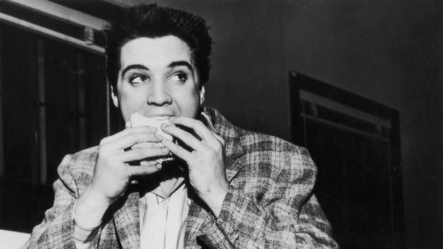 A still-trim Elvis Presley enjoys a sandwich in 1958. His love of fatty foods hadn't caught up to him yet. Photo: Hulton Archive/Getty Images