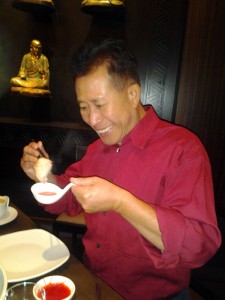 Martin Yan eating steamed dumplings at M.Y. China. Photo: Mary Ladd