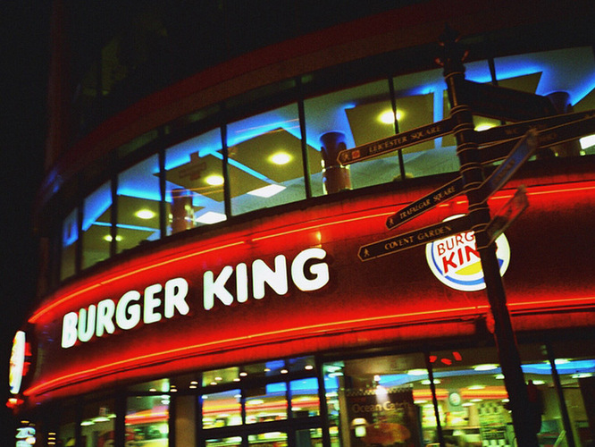 Signs point to tourist destinations outside a Burger King in London. Photo:  michaelpickard/Flickr